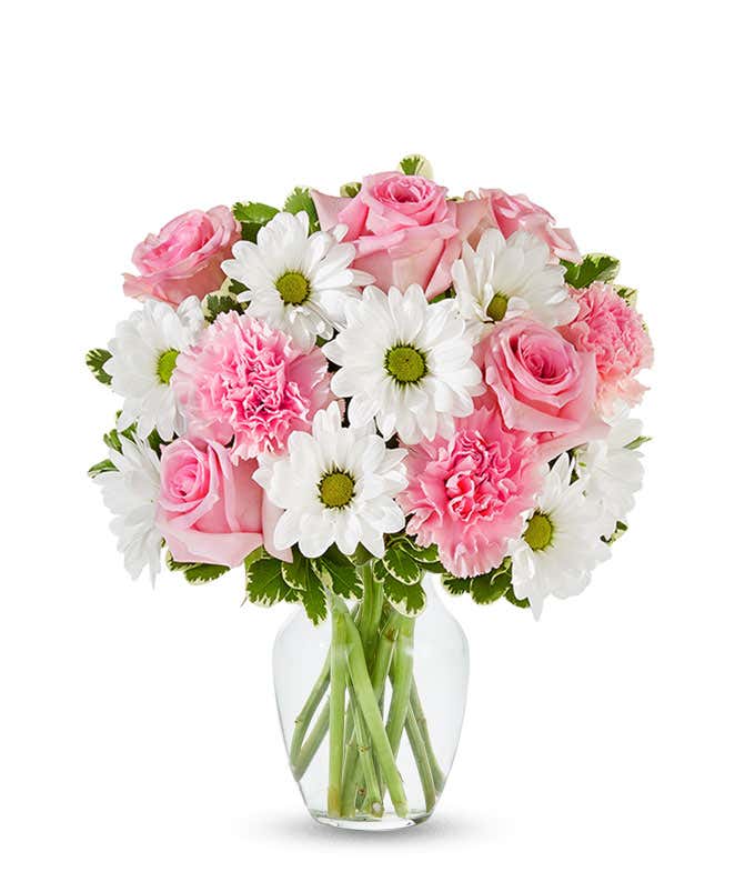 Pink roses, pink carnations and white daisies in a pink vase