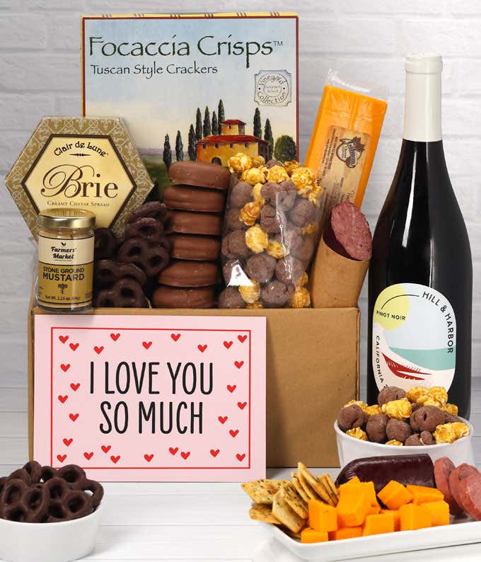 A gift featuring Hill & Harbor Pinot Noir, smoky sharp cheddar, Brie cheese, focaccia crisps, summer sausage, stone-ground mustard, chocolate-covered pretzels, chocolate-dipped cookies, caramel popcorn, and an 'I Love You So Much' message.