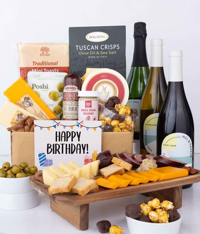 A wine and cheese gift set featuring 3 bottles of California wine - sparkling wine, Chardonnay, and Pinot Noir. Includes a variety of gourmet cheeses, crackers, olives, smoked almonds, summer sausage, and condiments.